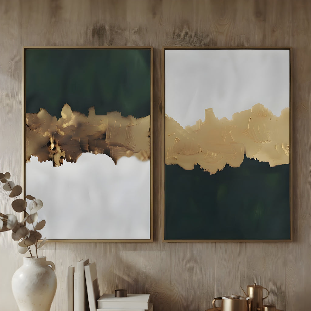 Two framed abstract wall art prints hang on a wood-paneled wall. Each print has a dark green upper section, a textured metallic gold middle band, and a white lower section.