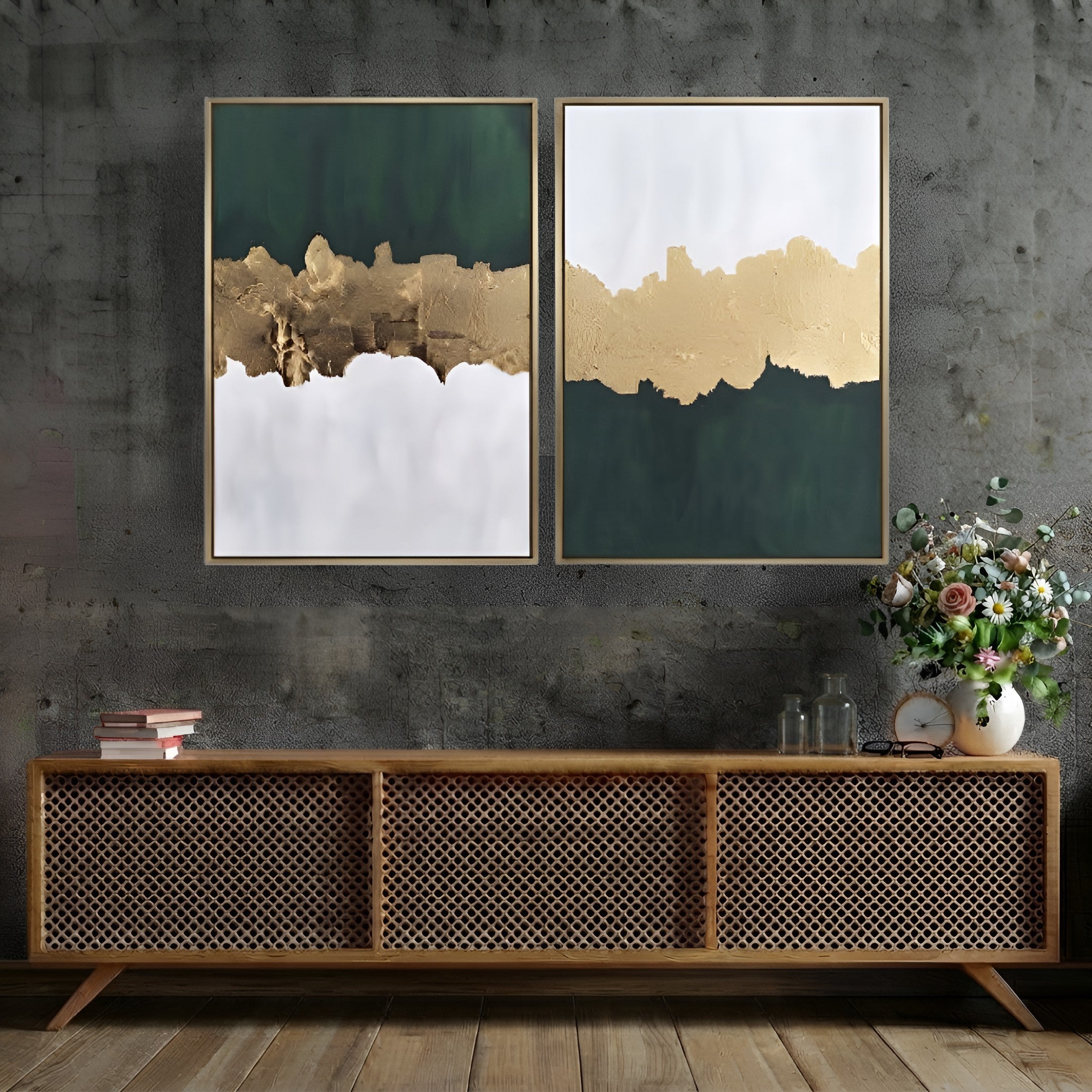 Two framed abstract wall art prints hang above a wooden sideboard against a dark textured wall. The artwork features dark green, metallic gold, and white color-blocked designs with thin gold frames.